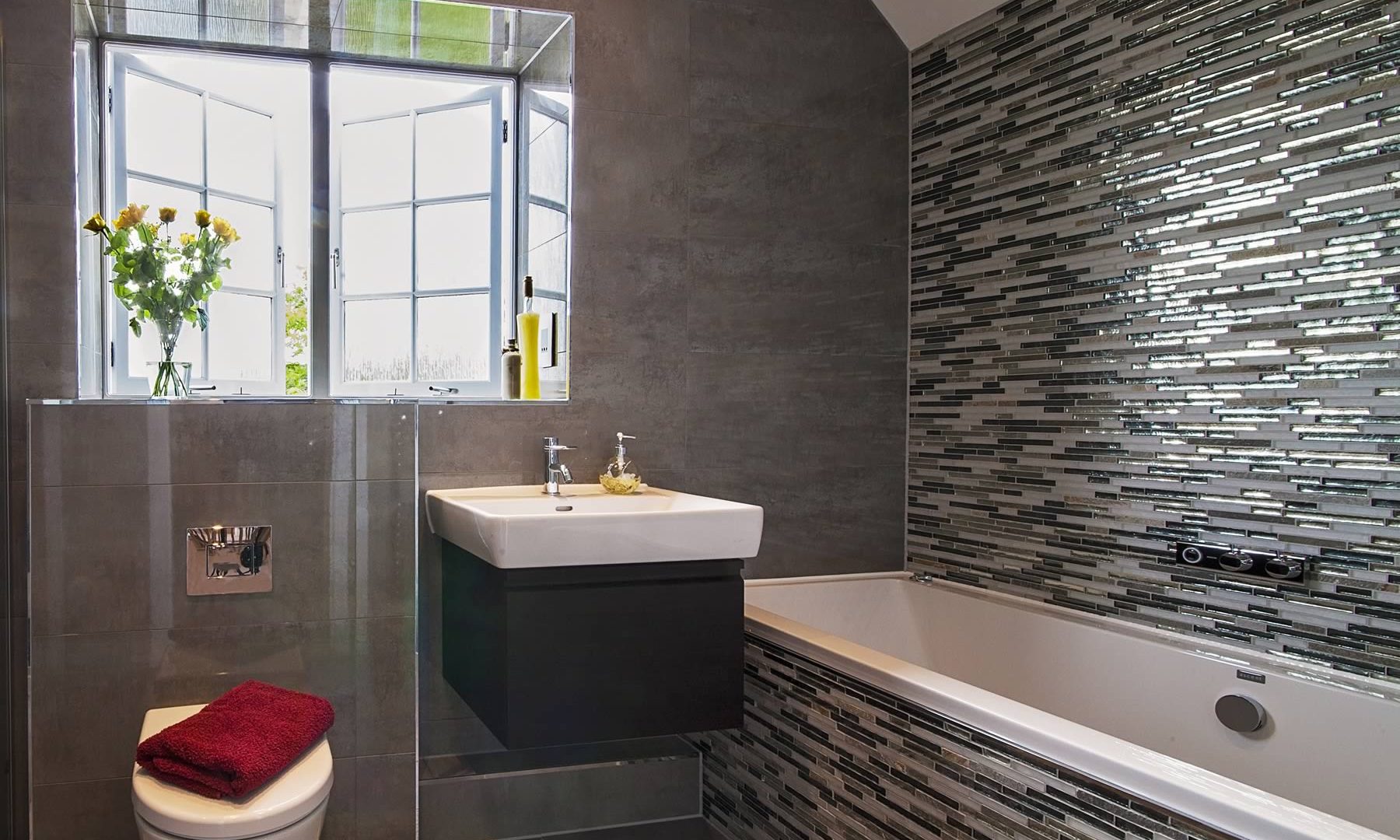 Fitted bathroom with mosaic tiles.