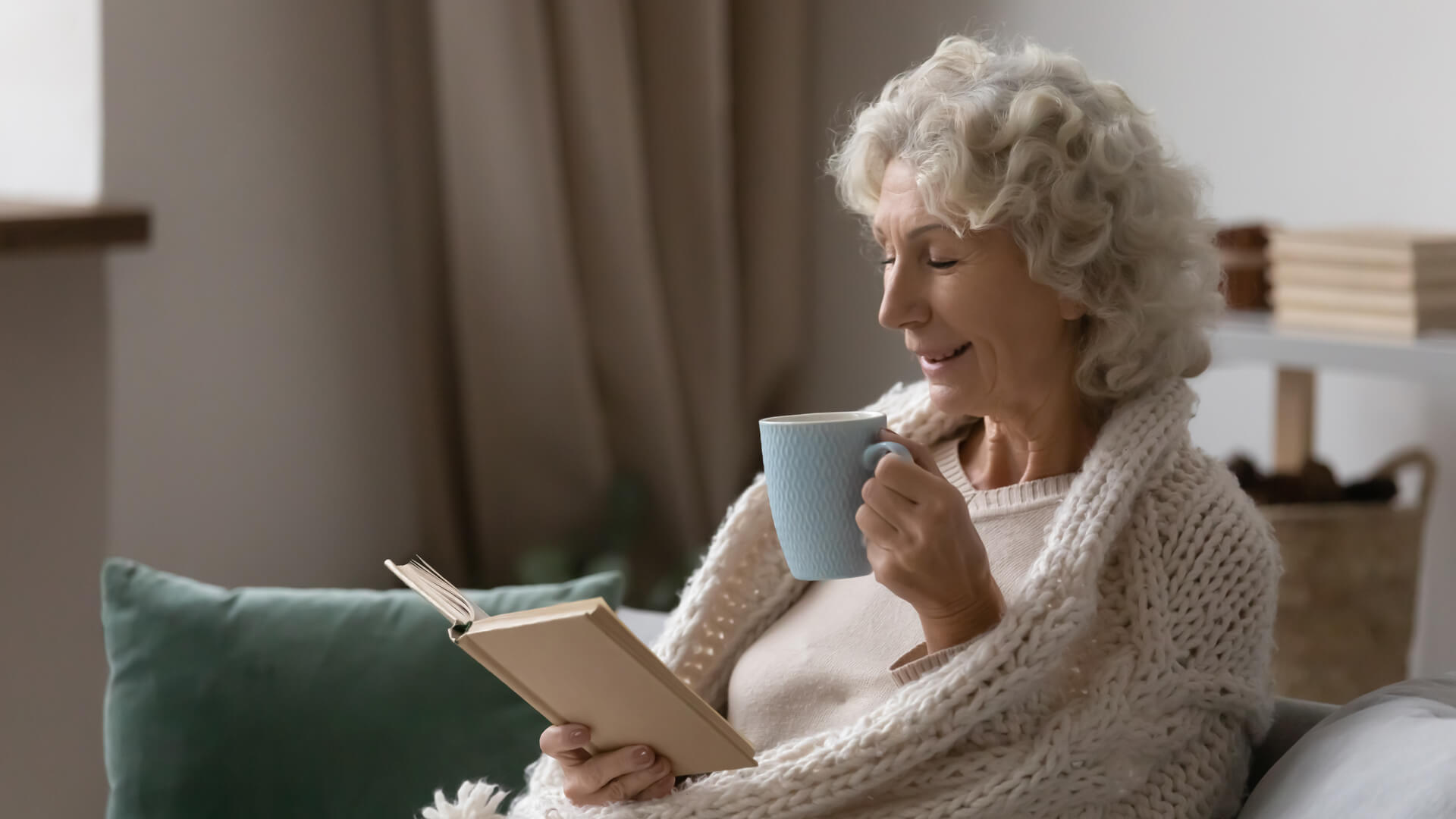 Elderly woman reading a book in her retirement