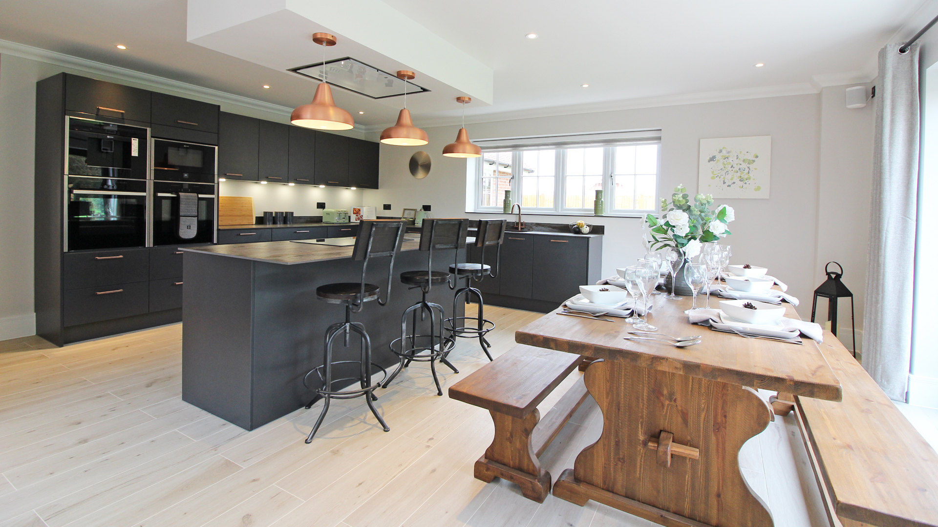 Fitted kitchen with rustic kitchen table and benches at Plot 14 Weavers park.
