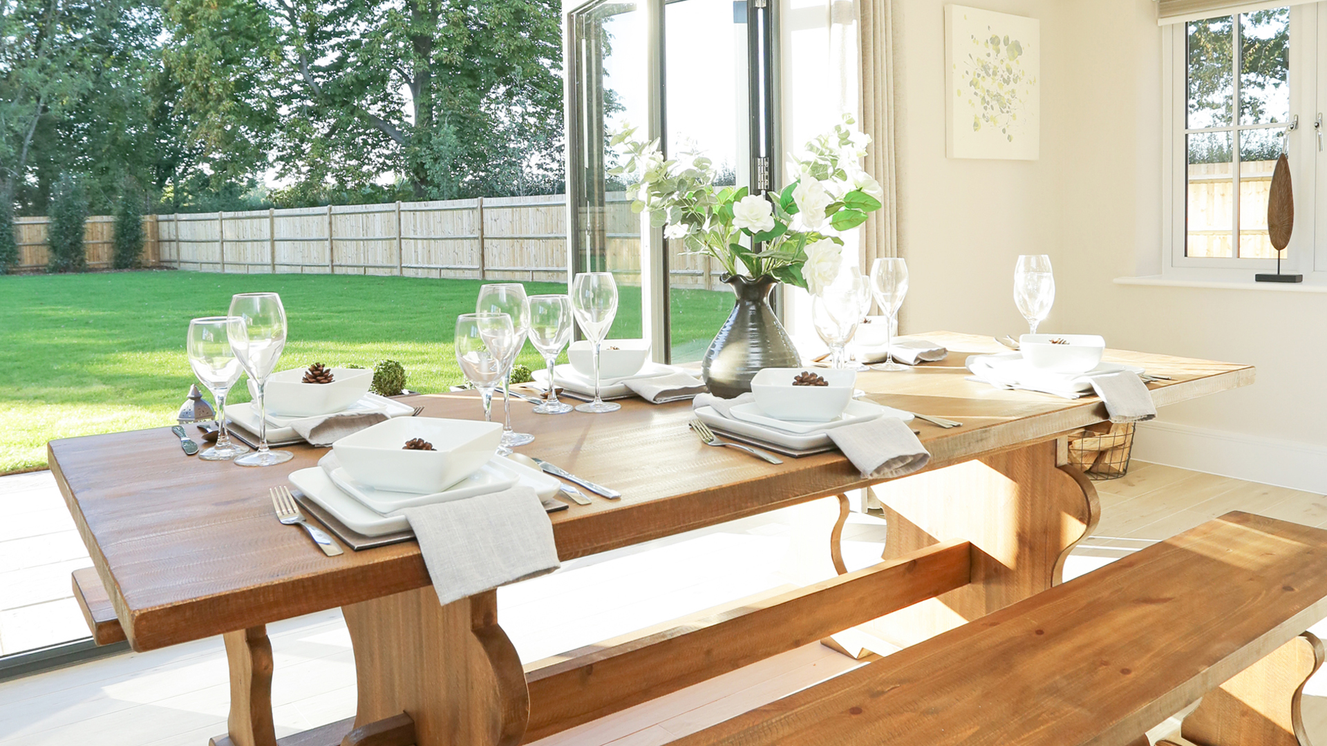 Dining table with doors open to the garden behind at plot 14 Weavers Park