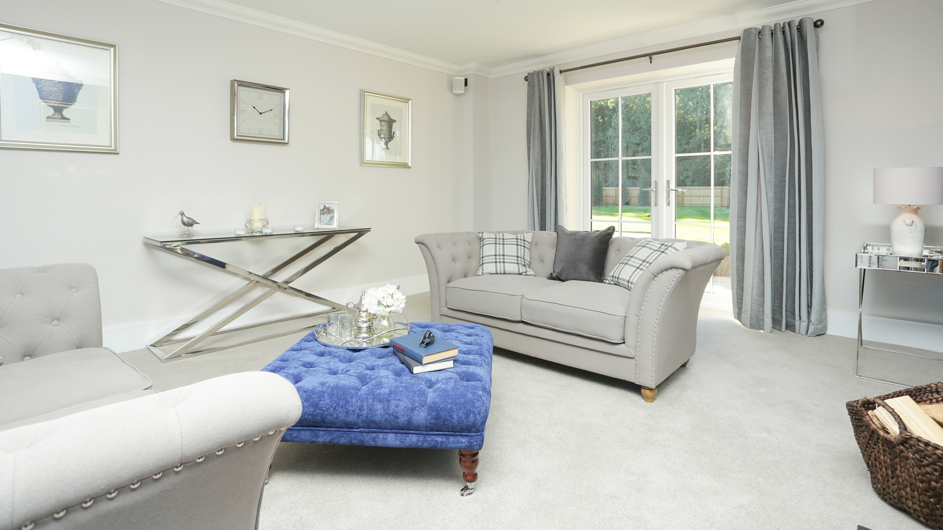 Weavers Park plot 14 living room with carpet, sofas and bifold doors