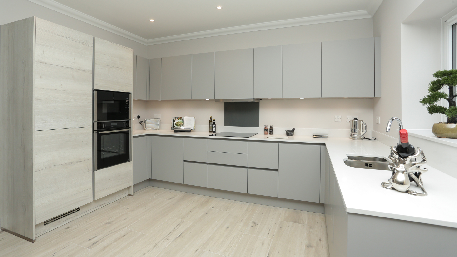 Cobnut Park plot 6 kitchen with grey cupboards and a hardwood floor.